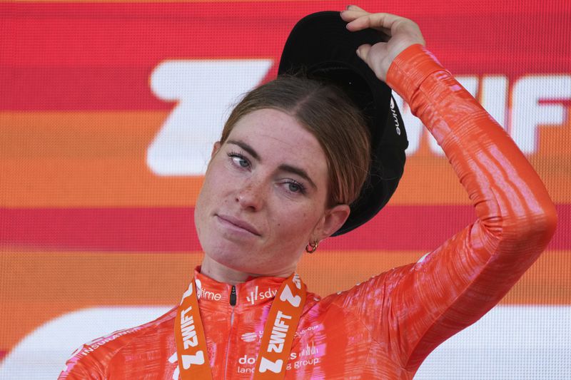 Stage winner Demi Vollering of The Netherlands reacts on the podium after the eighth stage of the Tour de France Women cycling race with start in Le Grand-Bornand and finish in Alpe d'Huez, France, Sunday, Aug. 18, 2024. (AP Photo/Peter Dejong)