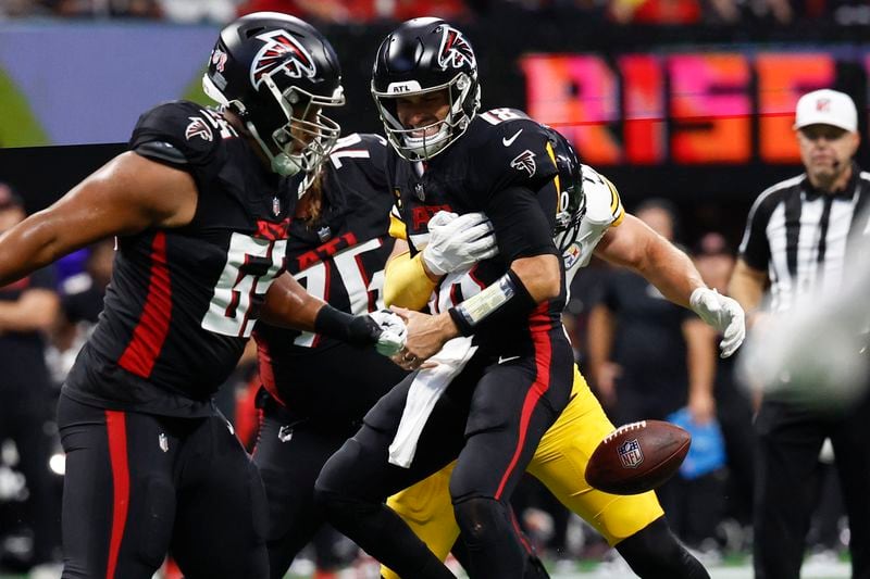 Atlanta Falcons quarterback Kirk Cousins (18) fumbles the ball after a hit from the Pittsburgh Steelers during the first half of an NFL football game Sunday, Sept. 8, 2024, in Atlanta. (AP Photo/Butch Dill)