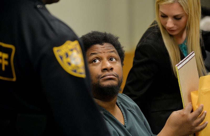 DECEMBER 5, 2014 LAWRENCEVILLE Calvin Mcintosh looks towards a deputy for instructions after being bound over for trial in 2014. Mcintosh and his daughter are charged with starving the man’s child to death and withholding food from the child’s 21-year-old mother, who weighed 59 pounds when she was found. KENT D. JOHNSON/KDJOHNSON@AJC.COM