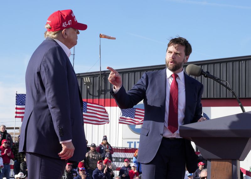 U.S. Sen. J.D. Vance, R-Ohio (right), points toward former President Donald Trump at a campaign rally in Vandalia, Ohio.