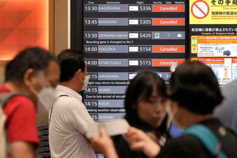 A departing flight information board shows that some flights were canceled due to an approaching Typhoon Shanshan at Haneda airport Thursday, Aug. 29, 2024, in Tokyo. (AP Photo/Eugene Hoshiko)