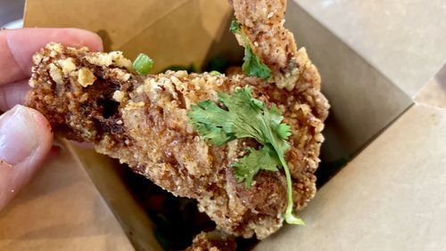 The spicy and numbing chicken wings from Ginsberg’s Refresher offer a super crisp, craggy skin covering juicy meat. (Angela Hansberger for The Atlanta Journal-Constitution)
