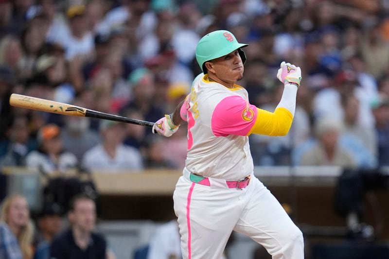 San Diego Padres' Manny Machado watches his RBI double during the fourth inning of a baseball game against the Atlanta Braves, Friday, July 12, 2024, in San Diego. (AP Photo/Gregory Bull)