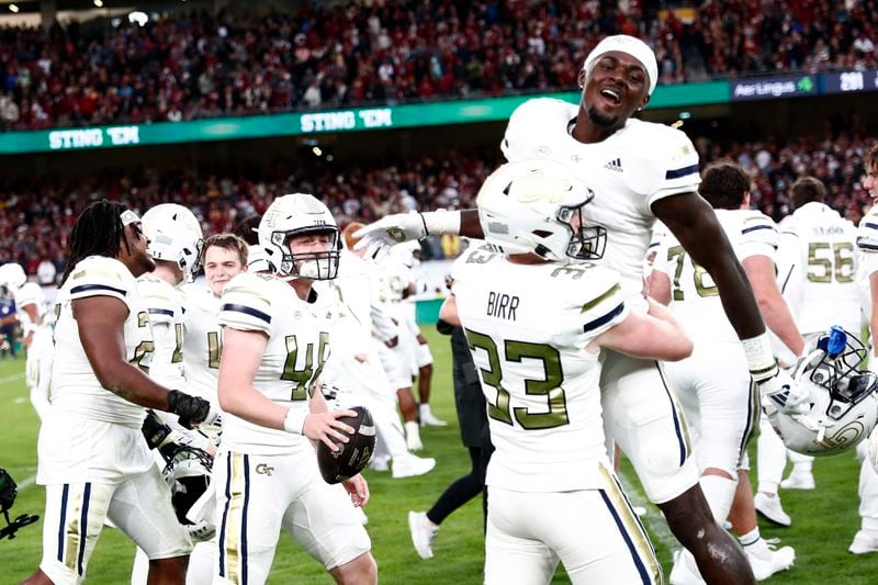 Georgia players celebrate after the NCAA college football game between Georgia Tech and Florida State at the Aviva stadium in Dublin, Saturday, Aug. 24, 2024. (AP Photo/Peter Morrison)