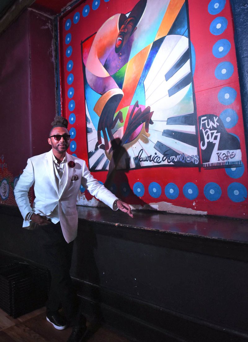 Jason Orr, the founder of FunkJazz Cafe, stands next to a mural in the Tabernacle, honoring his 25-year-old event. The mural was painted by Maurice Evans, an Atlanta artist who is a regular at the event with Orr.  The event happens Aug. 10 at the Tabernacle. Ryon Horne / RHORNE@AJC.COM