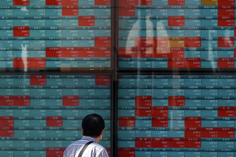 A person looks at an electronic stock board showing Japan's Nikkei index at a securities firm Wednesday, Oct. 2, 2024, in Tokyo. (AP Photo/Eugene Hoshiko)