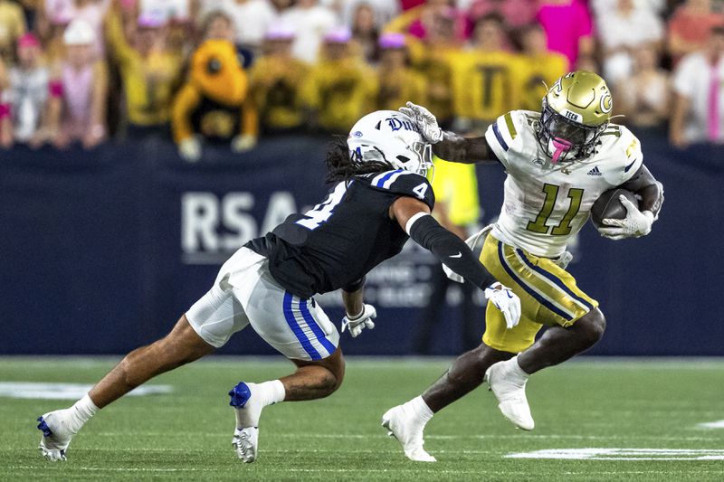 Georgia Tech Yellow Jackets running back Jamal Haynes (11) stiff arms Duke Blue Devils linebacker Cameron Bergeron (4) in the first quarter of a football game, Saturday, Oct. 5, 2024, in Atlanta. (AP Photo/Jason Allen)