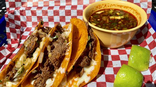 Birria tacos and consommé for dipping at Frida's Taqueria in Lilburn. (Angela Hansberger for The Atlanta Journal-Constitution)