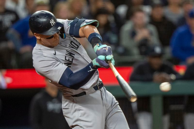 New York Yankees' Aaron Judge hits a two-run single during the second inning of a baseball game against the Seattle Mariners, Tuesday, Sept. 17, 2024, in Seattle. (AP Photo/Stephen Brashear)