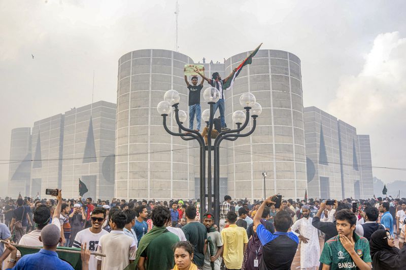 FILE- Anti-government protesters celebrate outside the Bangladesh Parliament after getting the news of Prime Minister Sheikh Hasina's resignation, in Dhaka, Bangladesh, Aug. 5, 2024. (AP Photo/Abid Hasan, File)