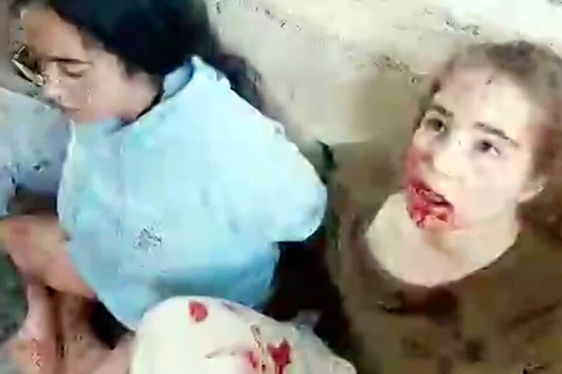 This image taken from video provided by the Hostage Families Forum, shows a bloodied Agam Berger, right, an Israeli female soldier from the Nahal Oz military base, after she was taken captive by Hamas on Oct. 7, 2023. The footage was taken by Hamas militants who stormed the Nahal Oz military base, part of the militant group’s wider assault on southern Israel that killed roughly 1,200 people and took about 250 others hostage. (Hostage Families Forum via AP)