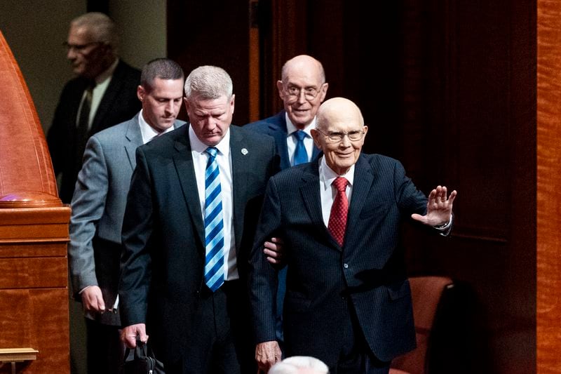 President Dallin H. Oaks, first counselor in The Church of Jesus Christ of Latter-day Saints' First Presidency, waves to the crowd as he enters with President Henry B. Eyring, second counselor in the First Presidency, during the twice-annual church conference at the Conference Center in Salt Lake City on Saturday, Oct. 5, 2024. (Isaac Hale/The Deseret News via AP)