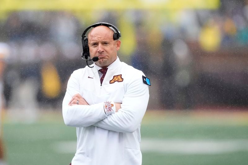 Minnesota head coach P.J. Fleck walks the sideline during the first half of an NCAA college football game against Michigan, Saturday, Sept. 28, 2024, in Ann Arbor, Mich. (AP Photo/Carlos Osorio)