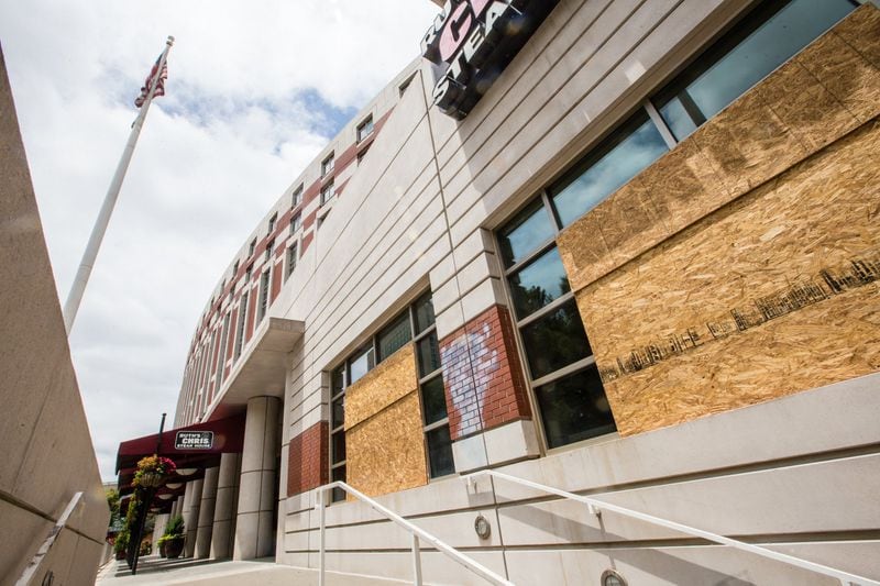 Ruth’s Chris Steak House at Centennial Olympic Park sustained damages from rioters and has several broken, boarded-up windows Wednesday, June 17, 2020. (Jenni Girtman for The Atlanta Journal-Constitution)