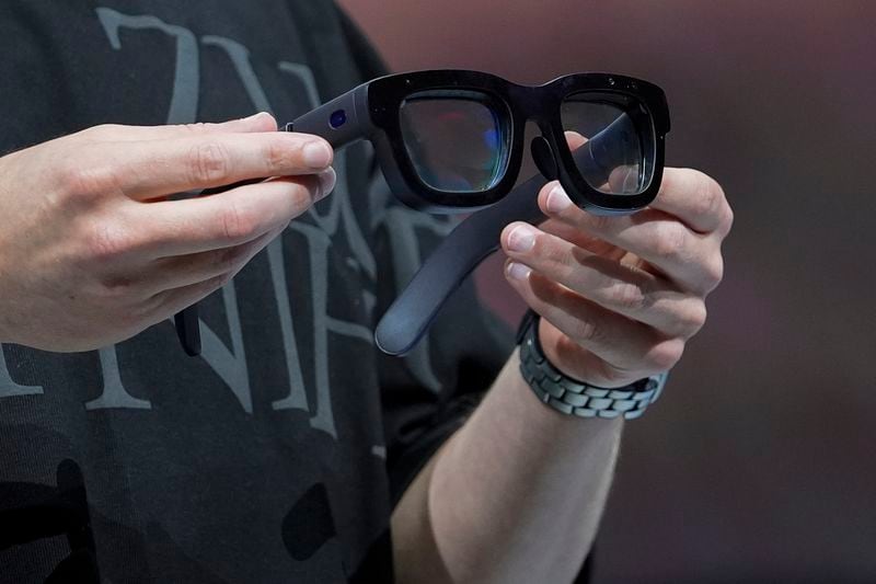 Mark Zuckerberg holds a pair of Orion AR glasses during the Meta Connect conference Wednesday, Sept. 25, 2024, in Menlo Park, Calif. (AP Photo/Godofredo A. Vásquez)