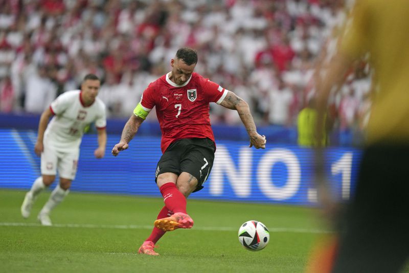 Austria's Marko Arnautovic (7) scores from the penalty spot during a Group D match between Poland and Austria at the Euro 2024 soccer tournament in Berlin, Germany, Friday, June 21, 2024. (AP Photo/Sunday Alamba)