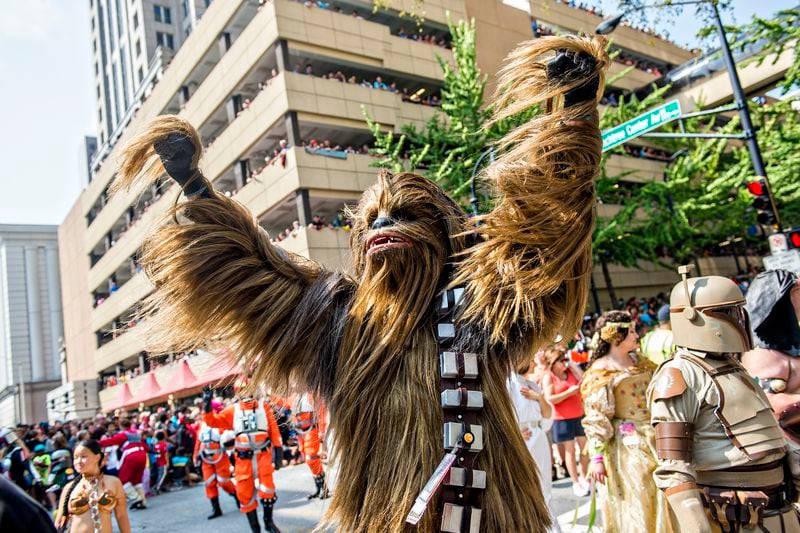 Dressed as Chewbacca, Matt Pfingsten throws his hands into the air during the annual DragonCon Parade in Atlanta on Saturday, September 5, 2015. JONATHAN PHILLIPS / SPECIAL