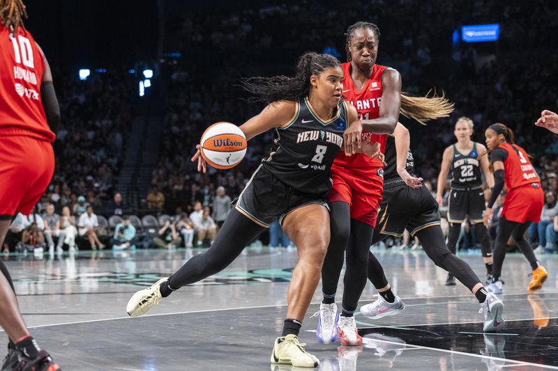 New York Liberty forward Nyara Sabally (8) is defended by Atlanta Dream center Tina Charles (31) during the first half of a WNBA first round game 1 playoff basketball game, Sunday, Sept. 22, 2024, in New York. (AP Photo/Corey Sipkin)