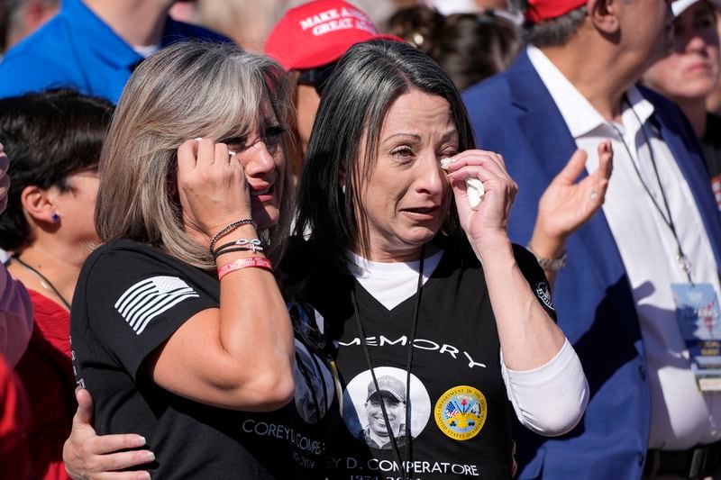 Kelly Comperatore-Meeder, left, and Dawn Comperatore-Schafer, sisters of firefighter Corey Comperatore, who died as he shielded family members from gunfire, cry at a campaign event for Republican presidential nominee former President Donald Trump, at the Butler Farm Show, the site where a gunman tried to assassinate Trump in July, Saturday, Oct. 5, 2024, in Butler, Pa. (AP Photo/Alex Brandon)