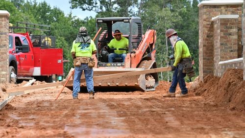 Crews at construction site for Alpha Loop section at Atley in Alpharetta. Construction is a sector where hiring has picked up, but job growth is not yet strong enough to make up for continued layoffs. (Hyosub Shin / Hyosub.Shin@ajc.com)