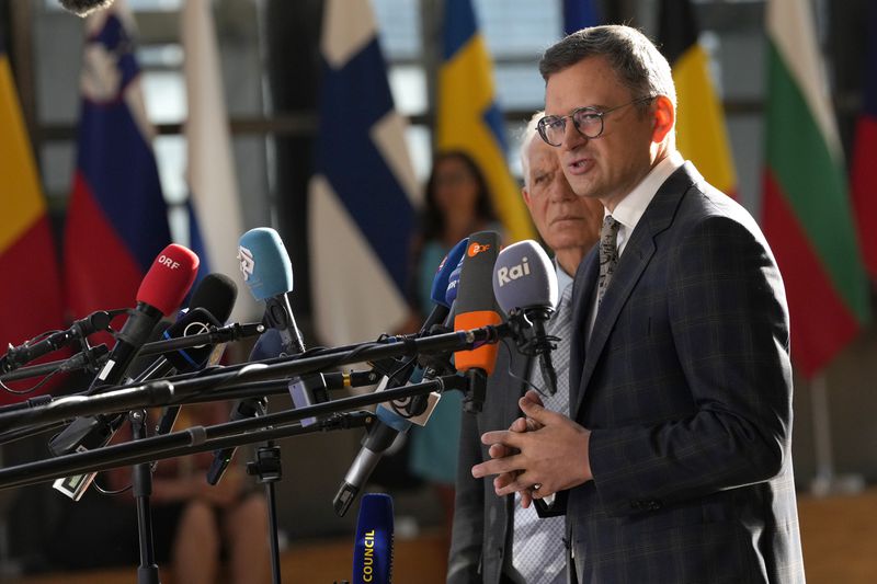 European Union foreign policy chief Josep Borrell, left, and Ukraine's Foreign Minister Dmytro Kuleba speak with the media as they arrive for a meeting of EU foreign ministers at the European Council building in Brussels, Thursday, Aug. 29, 2024. (AP Photo/Virginia Mayo)