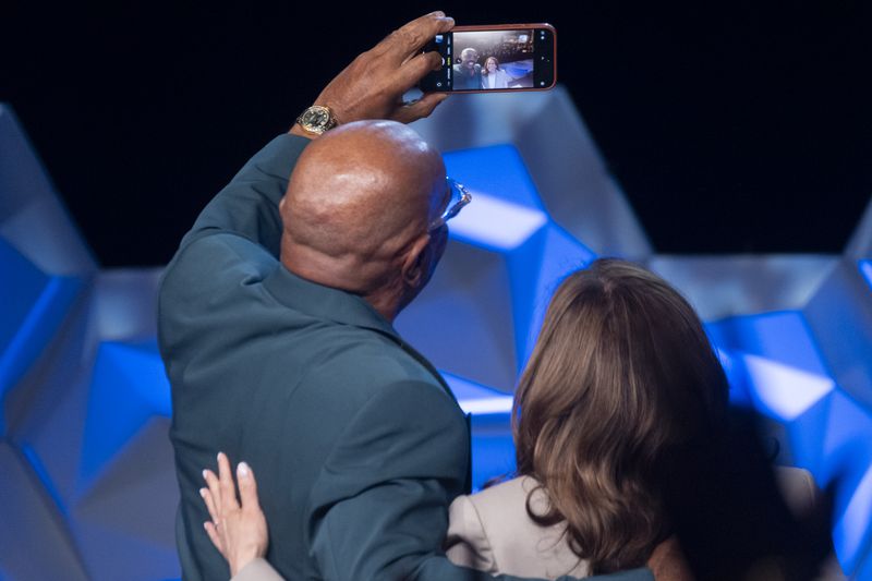 Comedian Steve Harvey and Vice President Kamala Harris take a selfie Friday after speaking at the 100 Black Men of America conference  in Atlanta. (Ben Gray / Ben@BenGray.com)