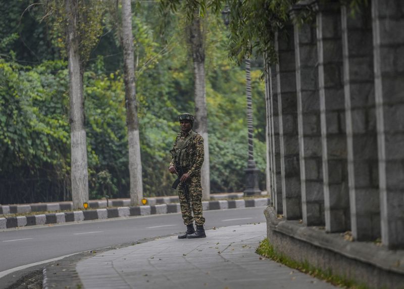 An Indian paramilitary soldier guards outside a vote counting center the recent election on the outskirts of Srinagar, Indian controlled Kashmir, Tuesday, Oct. 8, 2024. (AP Photo/Mukhtar Khan)