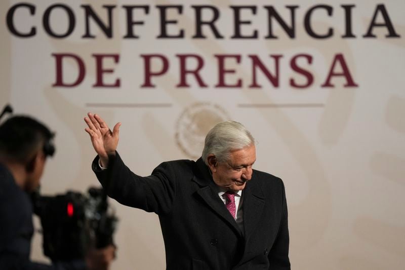 President Andres Manuel Lopez Obrador waves during his last morning press conference, or mañanera, at the National Palace in Mexico City, Monday, Sept. 30, 2024. (AP Photo/Fernando Llano)