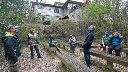 Steve Novotny (left) talks to friends as they take a short break while hiking the Whetstone Trail in Atlanta's Westside earlier this month. They routinely volunteered together at Habitat for Humanity before the pandemic made that impossible. Novotny now organizes hikes as a way to continue socializing in a distanced way. (Hyosub Shin / Hyosub.Shin@ajc.com)