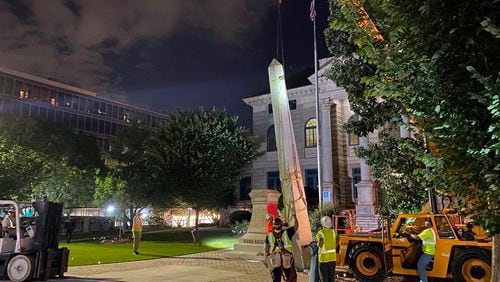 A 30-foot obelisk Confederate moment, which has stood for 112 years, was taken down in the downtown Decatur square late Thursday night. The monument was erected in 1908 by the United Daughters of the Confederacy. Photos by Amanda Coyne / AJC