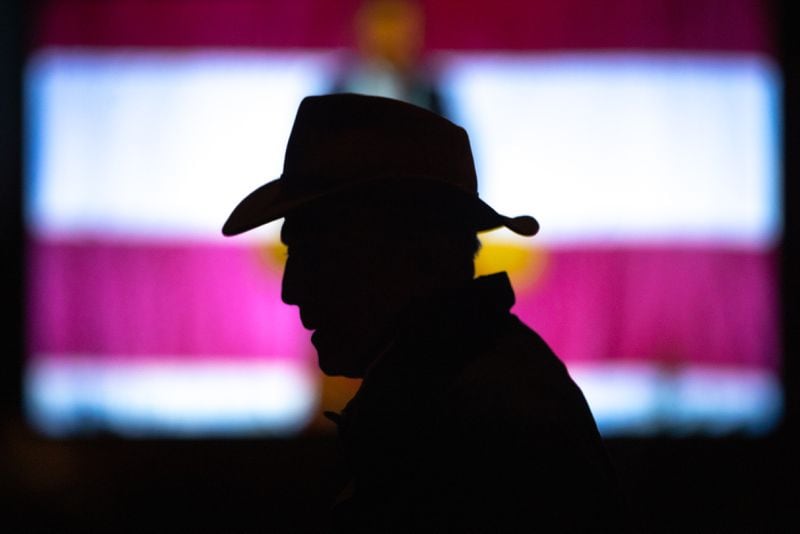 An attendee is silhouetted at the Georgia GOP Convention at the Columbus Convention & Trade Center in Columbus on Friday, May 17, 2024. (Arvin Temkar / AJC)