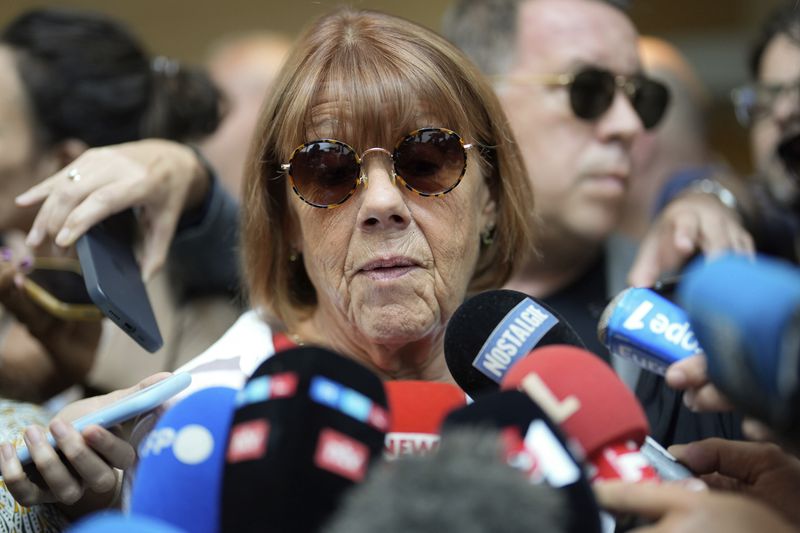 Gisele Pelicot speaks to media as she leaves the Avignon court house, southern France, Thursday, Sept. 5, 2024. A woman allegedly drugged by her ex-husband so that she could be raped by other men while she laid unconscious, is expected to testify before a panel of French judges. (AP Photo/Lewis Joly)