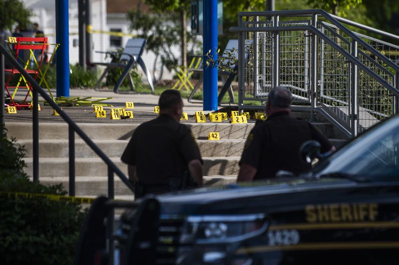 Officials with the Oakland County Sheriff's Department, Rochester Hills Fire Department and other jurisdictions secure the scene of a shooting at the Brooklands Plaza Splash Pad, Saturday, June 15, 2024, in Rochester Hills, Mich. (Katy Kildee/Detroit News via AP)
