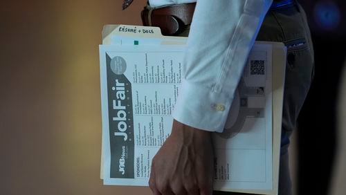 A person waits in a line for a prospective employer at a job fair, Thursday, Aug. 29, 2024, in Sunrise, Fla. (AP Photo/Lynne Sladky)