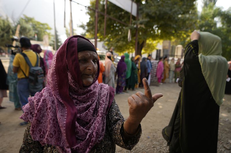 A woman shows the indelible ink mark on her finger after casting her vote during the first phase of the Jammu and Kashmir assembly election, in Kishtwar, India, Wednesday, Sept. 18, 2024. (AP Photo/Channi Anand)