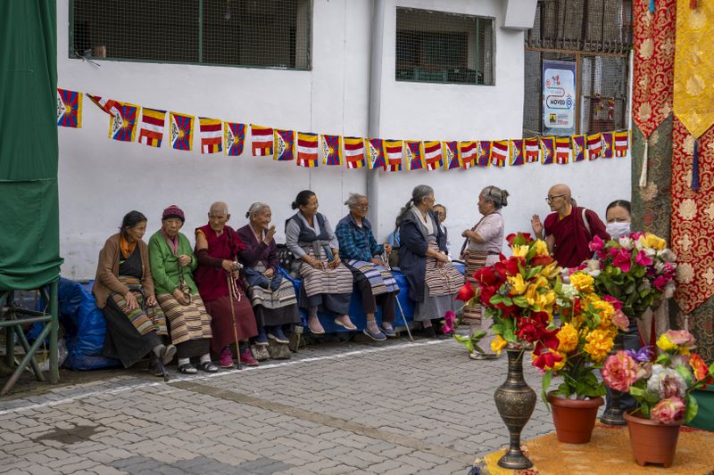 Exiled Tibetans wait to welcome their spiritual leader the Dalai Lama before he arrived in Dharamshala, India, Wednesday, Aug. 28, 2024. (AP Photo/Ashwini Bhatia)