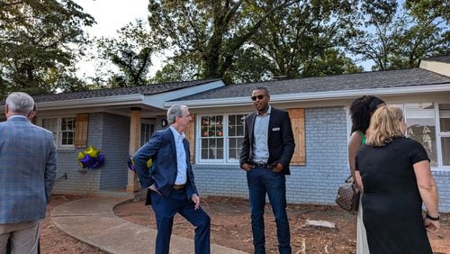 Family Promise board members Coye Mann (left) and Juron Dobbs tour the Roswell house recently donated to the nonprofit. Courtesy