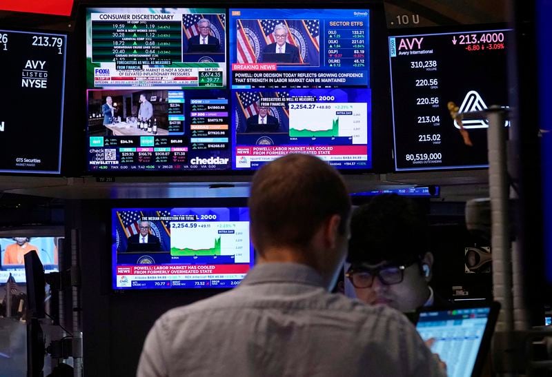 The news conference of Federal Reserve Chair Jerome Powell appears on television screens on the floor of the New York Stock Exchange, Wednesday, Sept. 18, 2024. (AP Photo/Richard Drew)