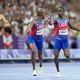 Christopher Bailey, of the United States, hands the baton to teammate Vernon Norwood, in the men's 4 x 400 meters relay final at the 2024 Summer Olympics, Saturday, Aug. 10, 2024, in Saint-Denis, France. (AP Photo/Ashley Landis)