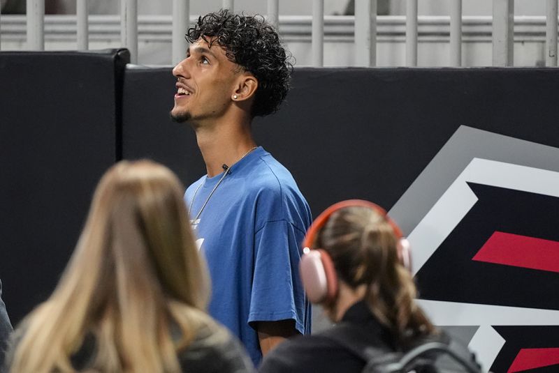 Atlanta Hawks NBA draft pick Zaccharie Risacher, of France, walks on the field before an NFL football game between the Atlanta Falcons and the Kansas City Chiefs, Sunday, Sept. 22, 2024, in Atlanta. (AP Photo/Brynn Anderson)