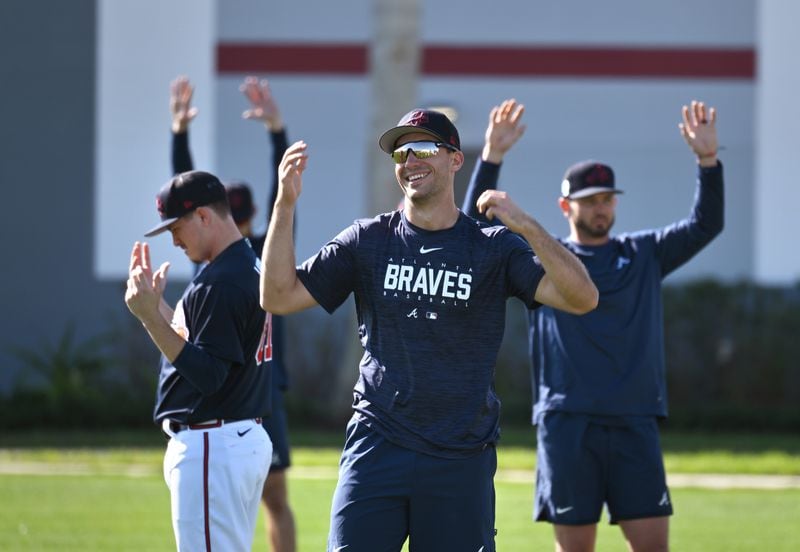 Braves first baseman Matt Olson smiles as he warms up with outfielder Kevin Pillar and other teammates during Braves spring training at CoolToday Park, Saturday, Feb. 18, 2023, in North Port, Fla. (Hyosub Shin / Hyosub.Shin@ajc.com)