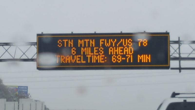 A Georgia Department of Transportation sign warned drivers on I-285 East after Peachtree Industrial Boulevard that it would take as long as 71 minutes to travel 6 miles. NANCY CLANTON / NANCY.CLANTON@AJC.COM