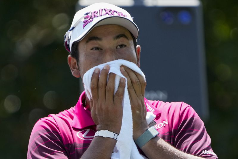 Hideki Matsuyama, of Japan, wipes his face on the 18th tee during the second round of the St. Jude Championship golf tournament Friday, Aug. 16, 2024, in Memphis, Tenn. (AP Photo/Mark Humphrey)