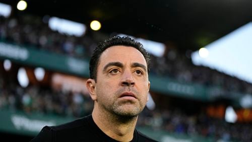 FILE - Barcelona's head coach Xavi Hernandez looks out onto the pitch before a Spanish La Liga soccer match between Betis and Barcelona at the Benito Villamarin stadium in Seville, Spain, on Jan. 21, 2024. Barcelona says coach Xavi Hernandez is leaving the club at the end of the season. The Spanish club made the announcement Friday May 24, 2024 after a meeting between club president Joan Laporta, Xavi and several other senior figures at the team's training ground. (AP Photo/Jose Breton, File)