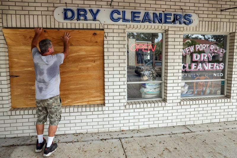 Jay McCoy puts up plywood in preparation for Hurricane Milton on Monday, Oct. 7, 2024, in New Port Richey, Fla. (AP Photo/Mike Carlson)