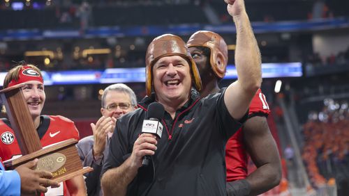 Georgia coach Kirby Smart celebrates with the old leather helmet after their win against Clemson at Mercedes-Benz Stadium, on Saturday, Aug. 31, 2024, in Atlanta. Georgia won 34-3. (Jason Getz / AJC)