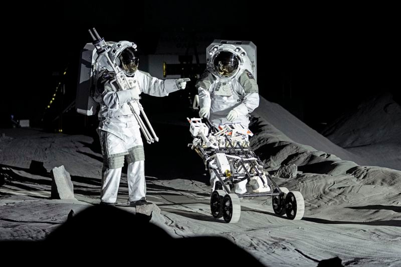 Astronauts Thomas Pesquet of France and Matthias Maurer of Germany demonstrate their training in lunar surface simulating conditions for future moon missions, like the Artemis lunar exploration program led by NASA, at the opening of the new LUNA facility at the European Astronaut Center in Cologne, Germany, Wednesday, Sept. 25, 2024. (AP Photo/Martin Meissner)