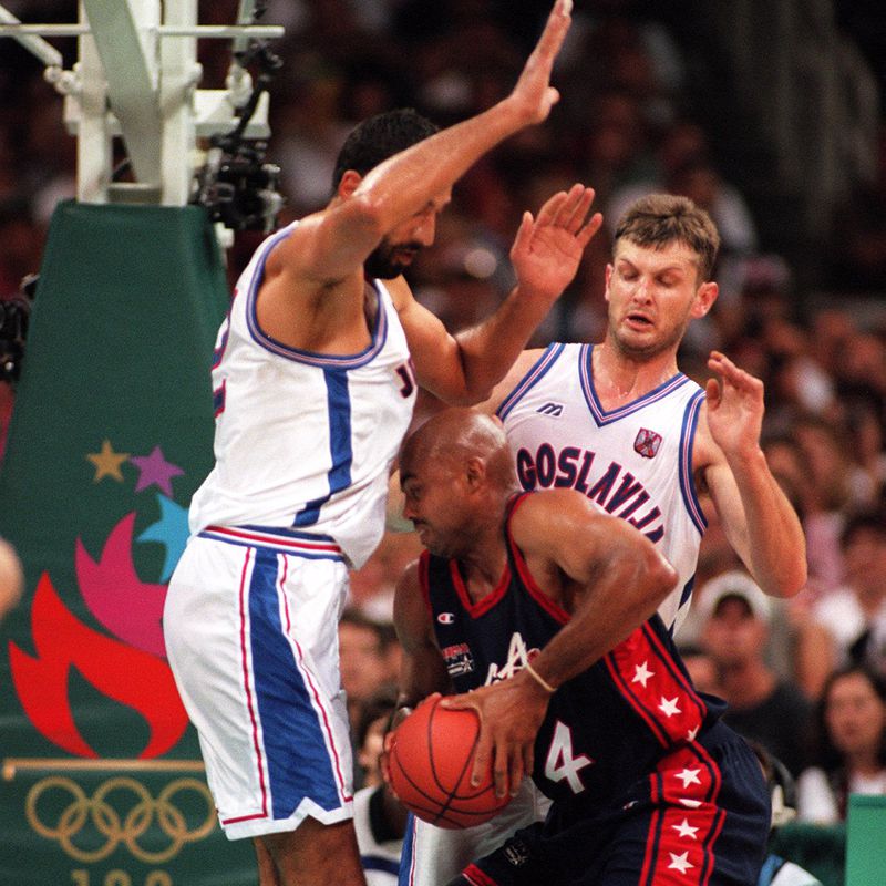 Yugoslavia's Vlade Divac, surrounds Charles Barkley of the U.S. men's basketball Dream Team with the help of his teammate Zarko Paspalj during the gold medal game Saturday, Aug. 3, 1996, during the 1996 Summer Olympic Games in Atlanta. (John Spink/AJC)
