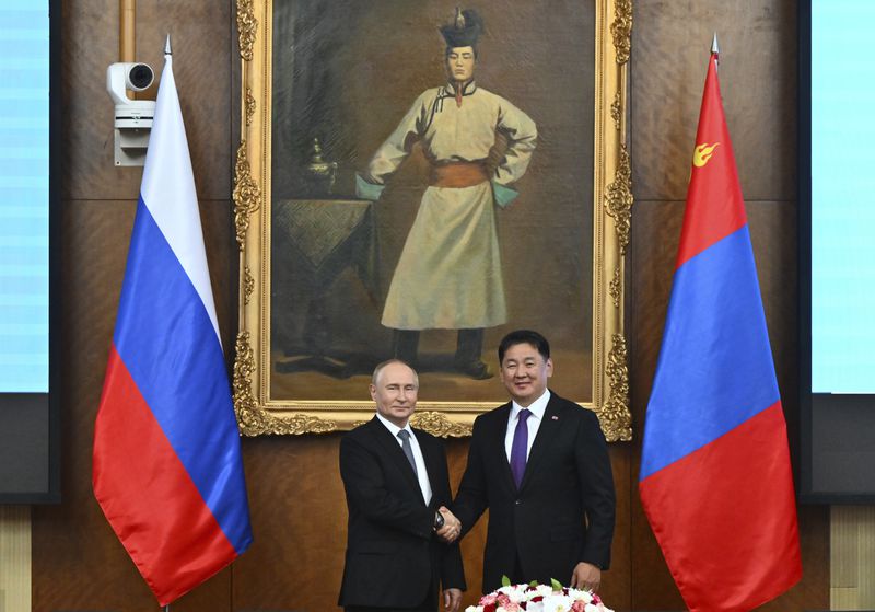 Russian President Vladimir Putin, left and Mongolian President Ukhnaagiin Khurelsukh shake hands as they pose for photos prior to the Russian-Mongolian talks at the Saaral Ordon Government Building in Ulaanbaatar, Mongolia, Tuesday, Sept. 3, 2024. (Kristina Kormilitsyna, Sputnik, Kremlin Pool Photo via AP)