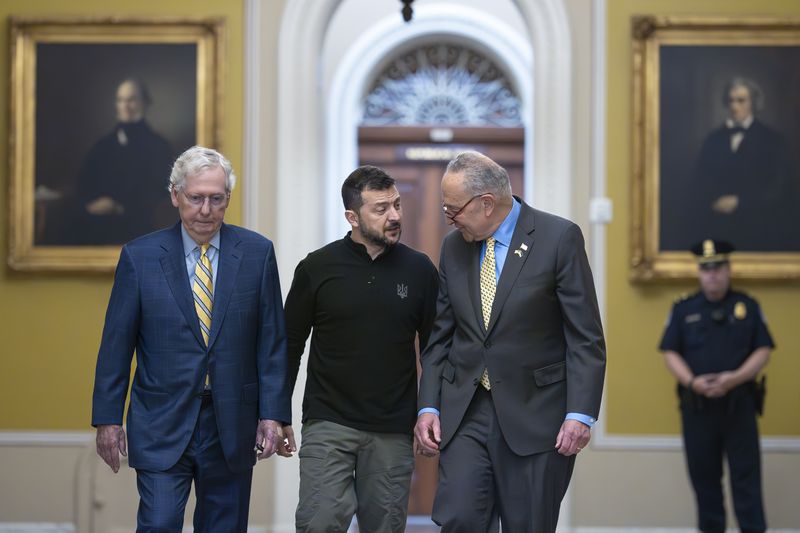 Ukrainian President Volodymyr Zelenskyy, center, walks with Senate Minority Leader Mitch McConnell, R-Ky., left, and Senate Majority Leader Chuck Schumer, D-N.Y., as he arrives for a briefing with lawmakers about the war effort against Russia, at the Capitol in Washington, Thursday, Sept. 26, 2024. (AP Photo/J. Scott Applewhite)